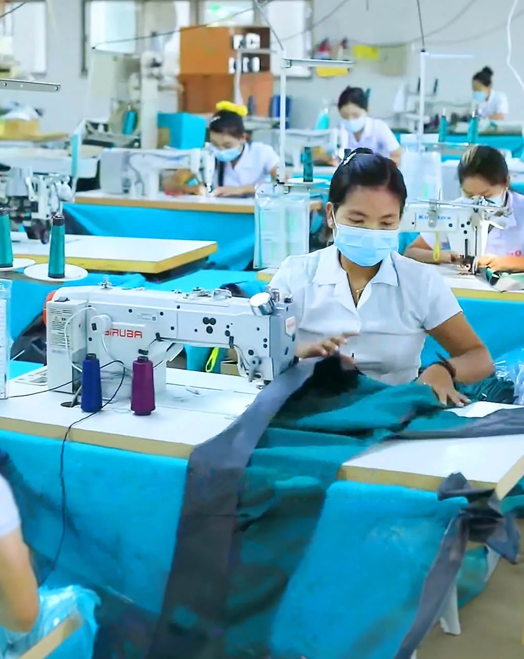 Women holding fabric mat